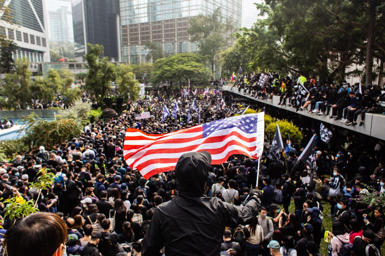 A protester waves an American flag in Hong Kong.