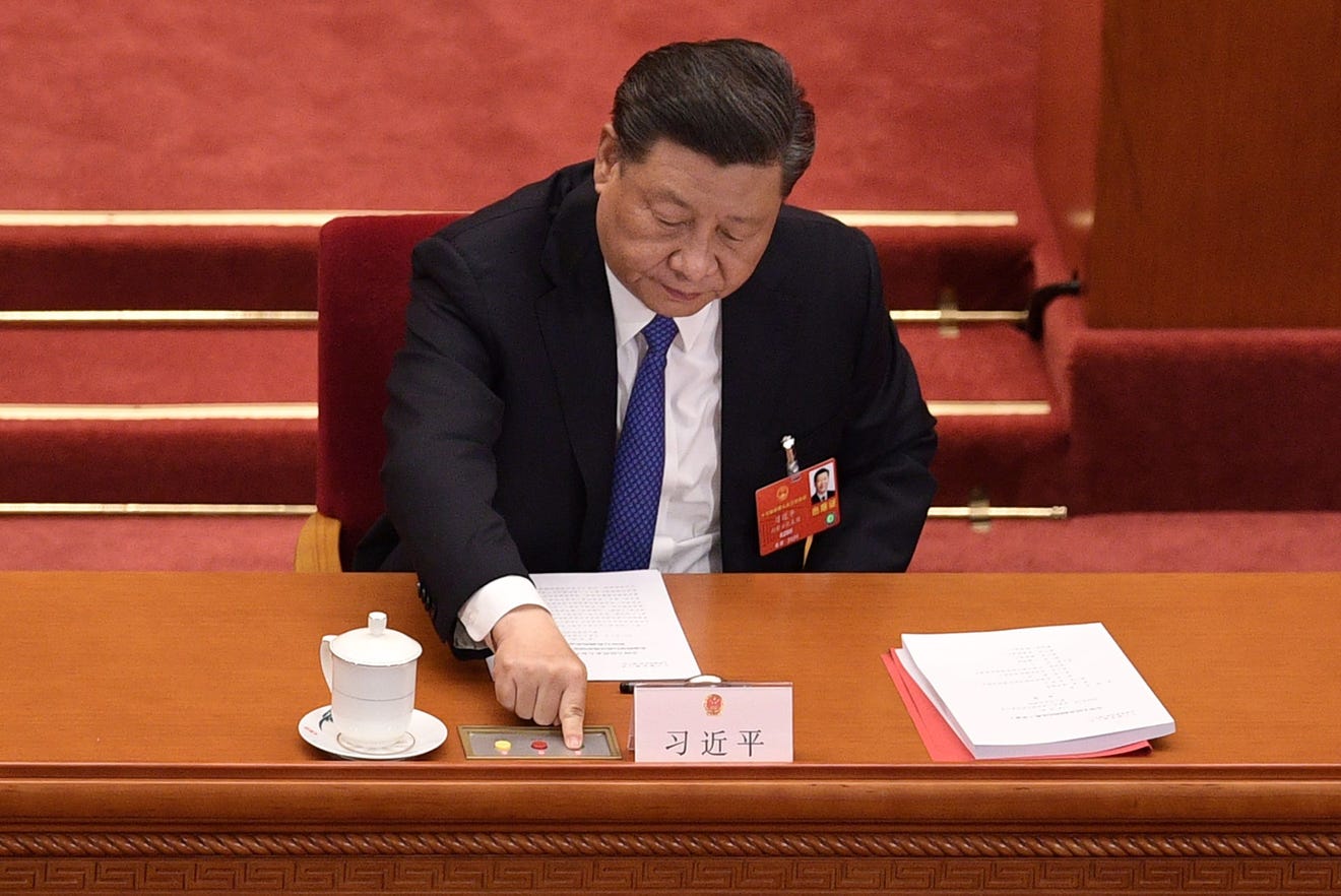 General Secretary of the Communist Party of China Xi Jinping signing documents